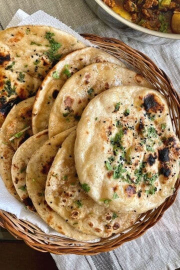 Plain atta kulcha in a bread basket.