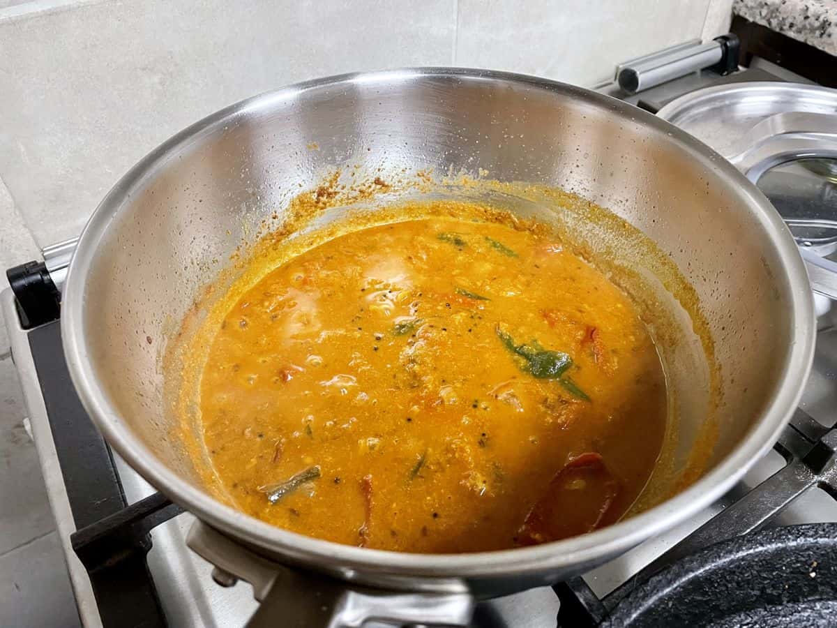 Cooked onion tomato masala with water.