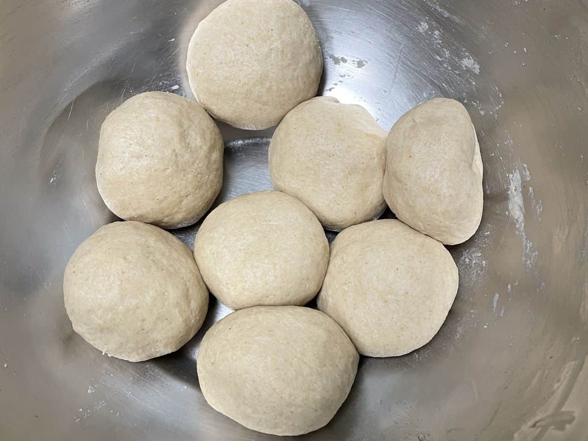 Chapati dough divided into 8 balls.