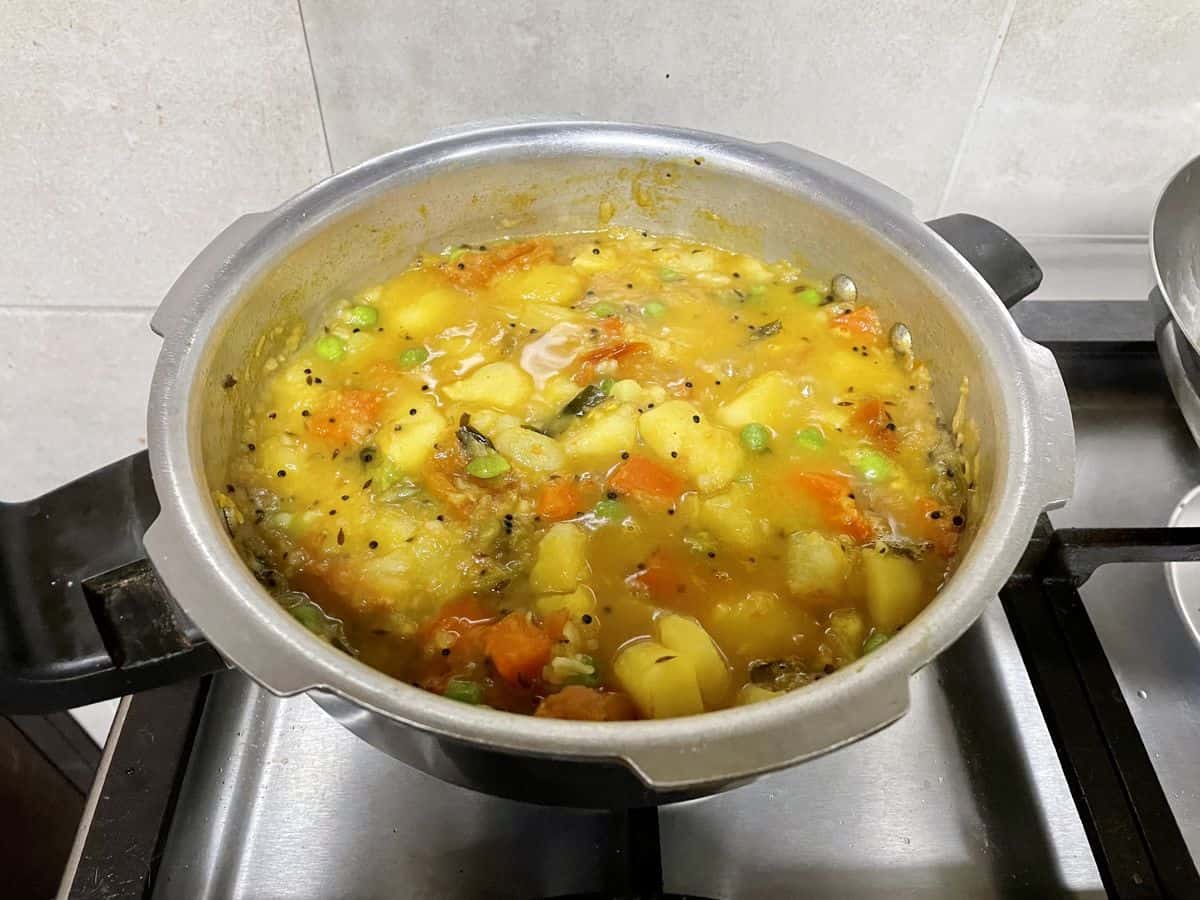 poori masala boiling in a pressure cooker. 