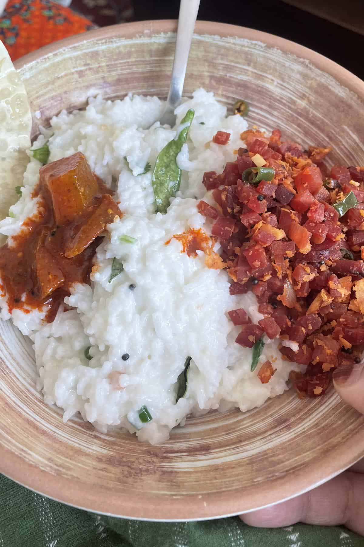 A bowl of buttermilk rice with pickle.