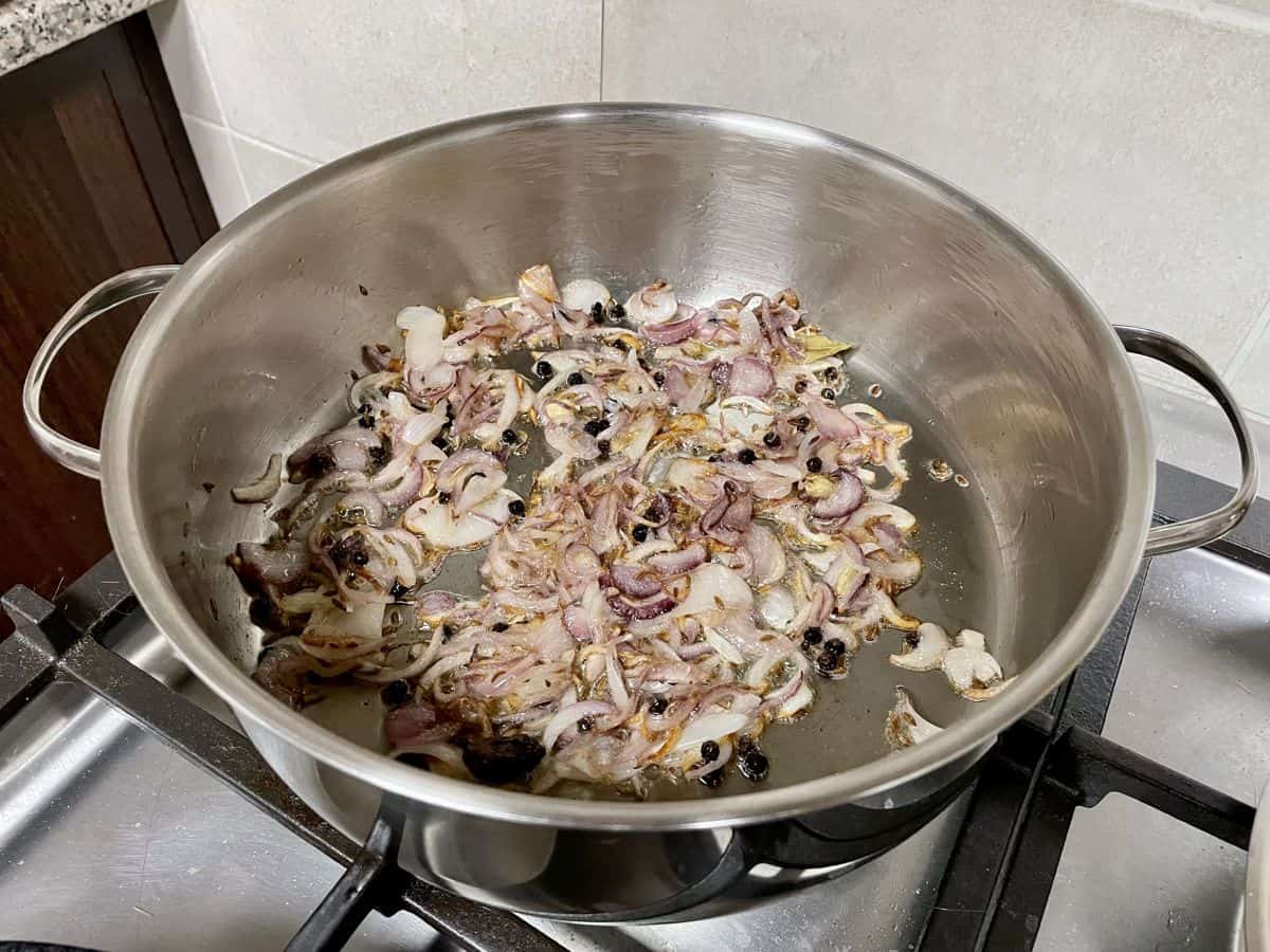 frying whole spices and onions in a wide saucepot.