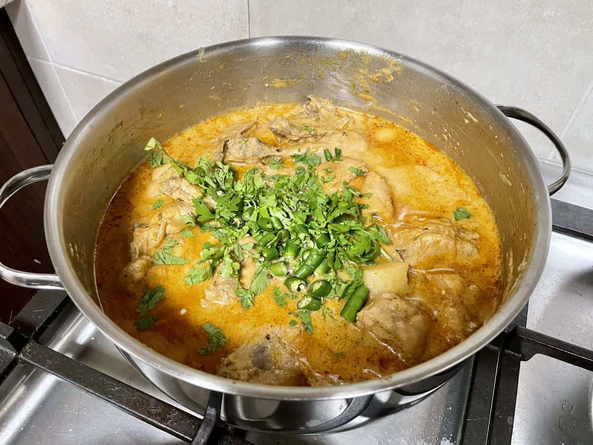 chicken korma with yoghurt garnished with coriander leaves