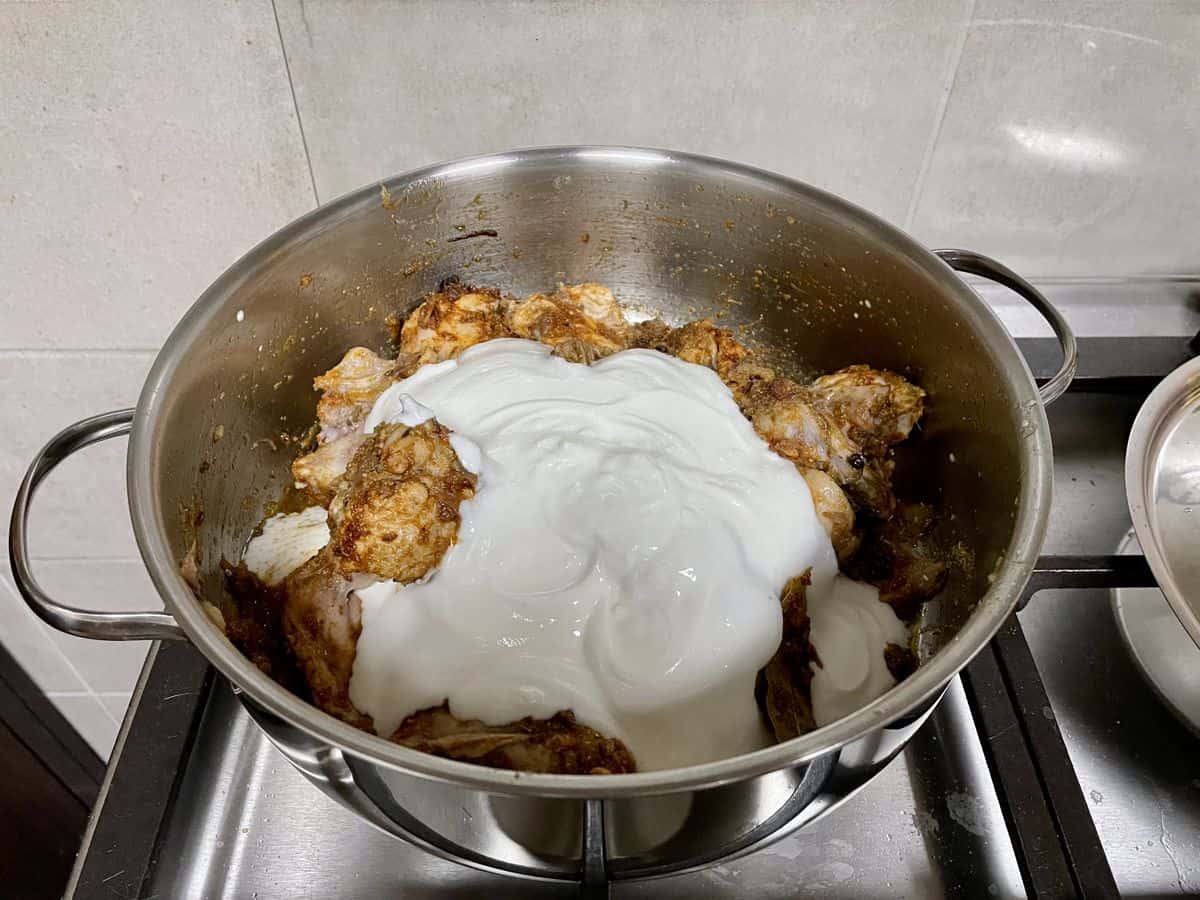 whisked yoghurt poured over seasoned chicken pieces.