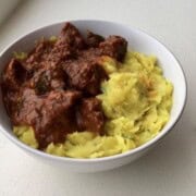 Kaapa served in a bowl with beef curry.