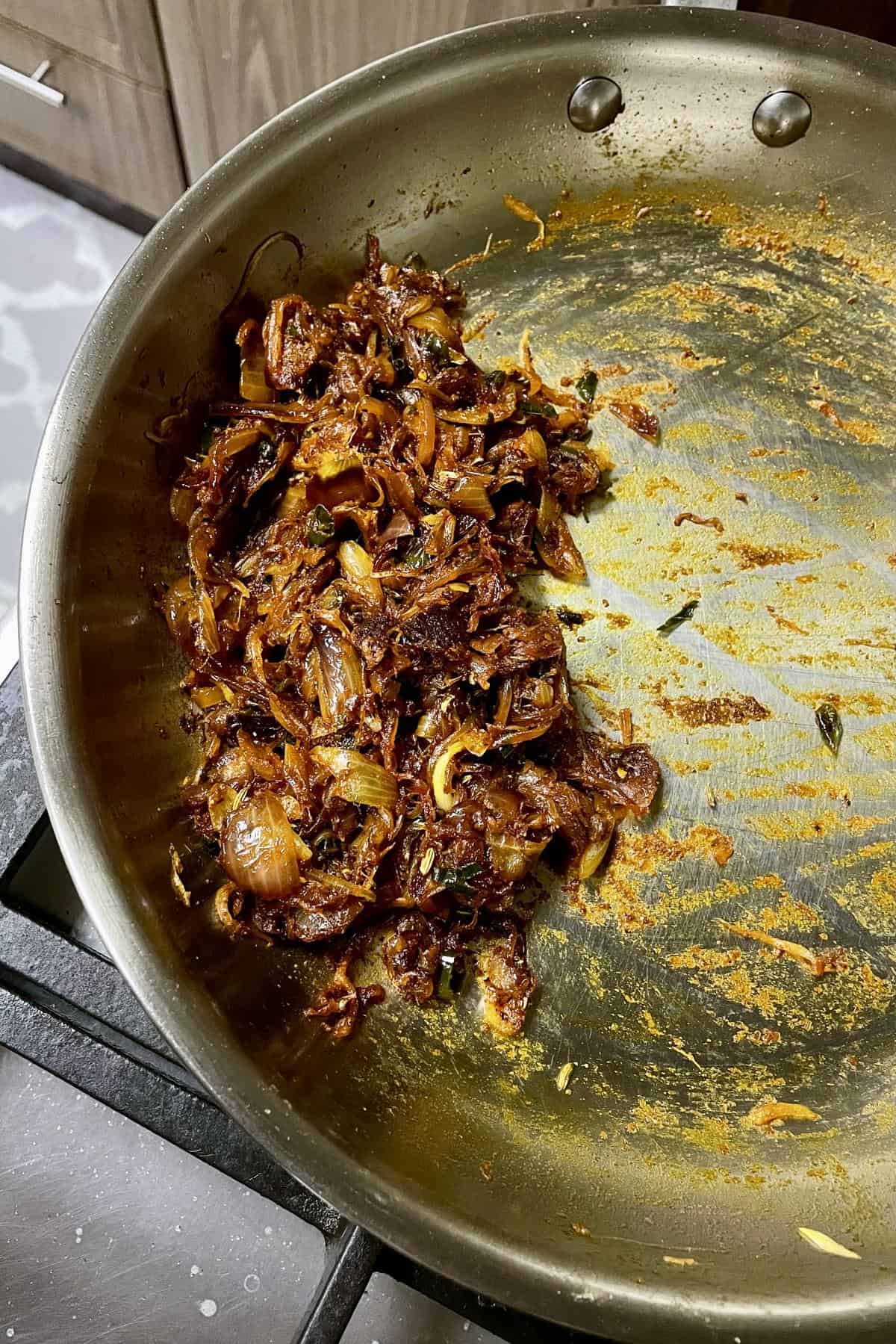 inished dry spicy onion masala for Kerala bakery-style egg puffs, cooked down completely in pan