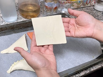 a puff pastry square held in hand