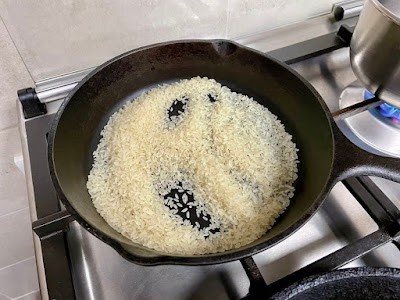 dry roasting rice grains in a cash iron skillet