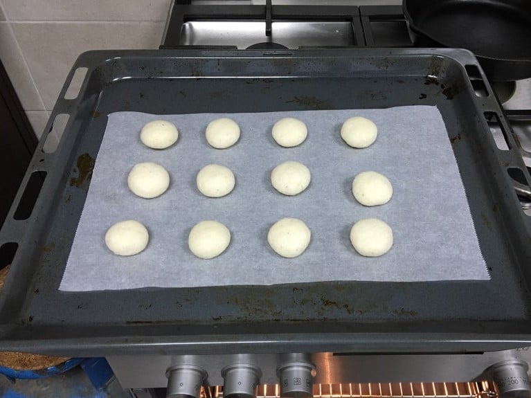 shaped macaroos on a lined baking sheet