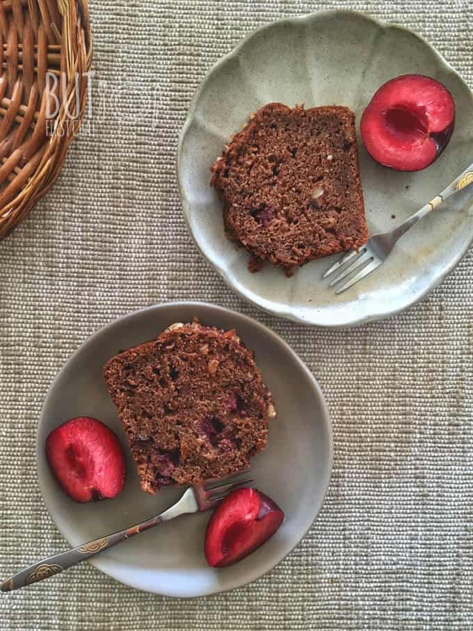 two mini dessert plate with slice of banana bread with plums