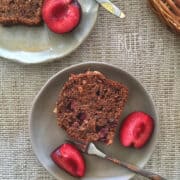 slice of banana plum bread with halved plums and forks