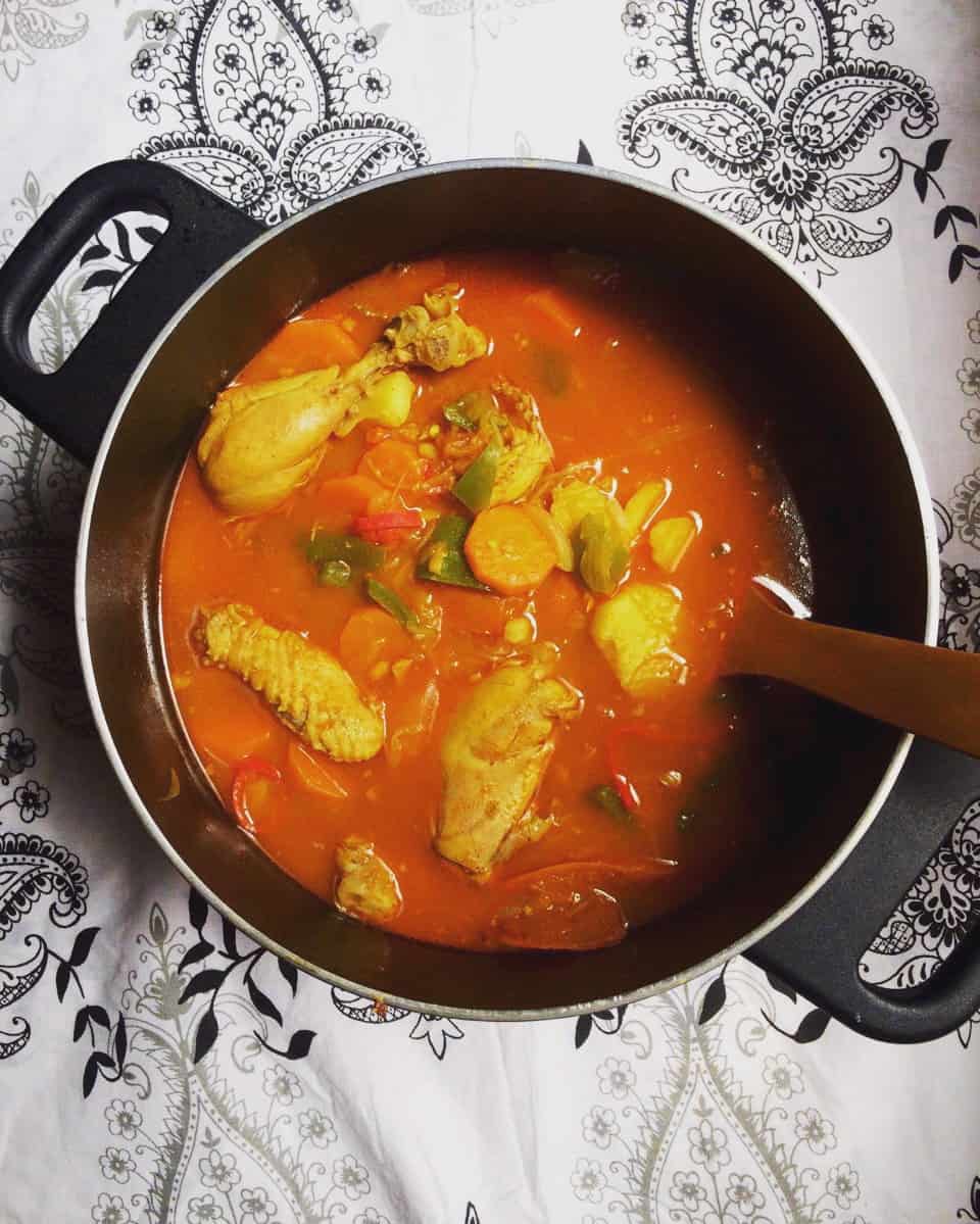 A pot of chicken salona with a ladle.