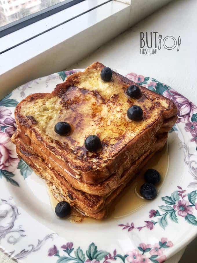 French Toast stacked with blueberries and maple syrup