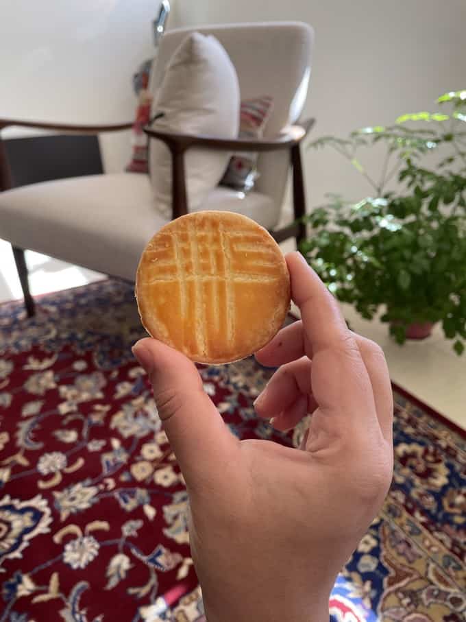 Holding one Galette Bretonne Biscuit between index and thumb