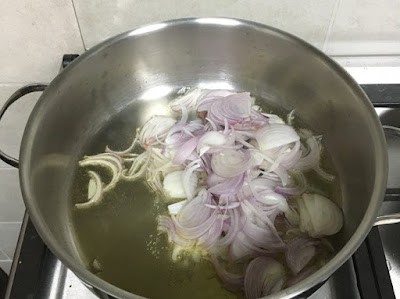 sliced onions being sauted in oil