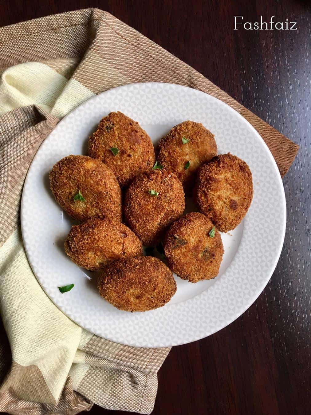 fried chicken cutlets on a white round plate