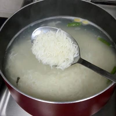 scooped a ladle of par-boiled rice