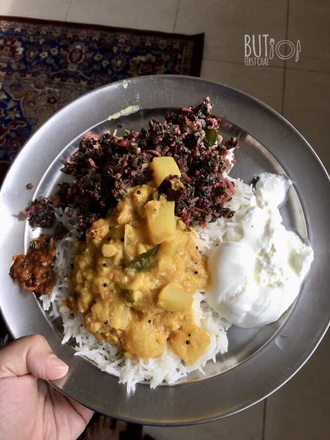 kumbalanga curry over a bed or white rice along with some curd and stir fried amaranth leaves and pickle