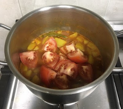 chopped tomatoes added to the pot