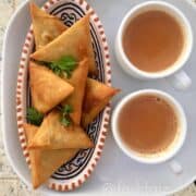 samosas with two cups of chai