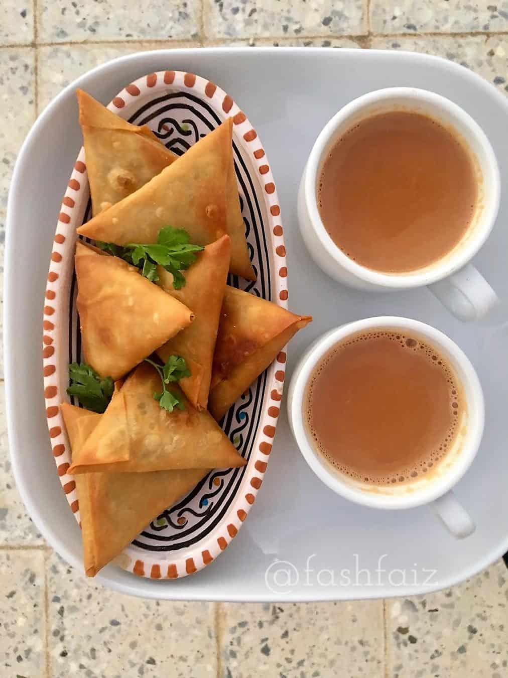 samosas with two cups of chai