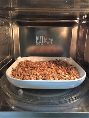 inside a microwave. Granola in a pan. 