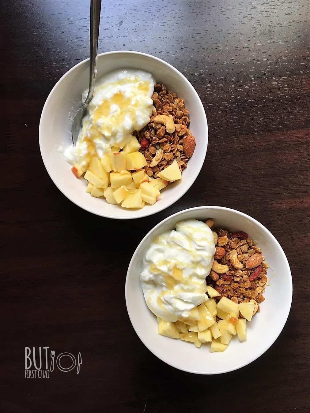 two bowls of granola with yoghurt and honey