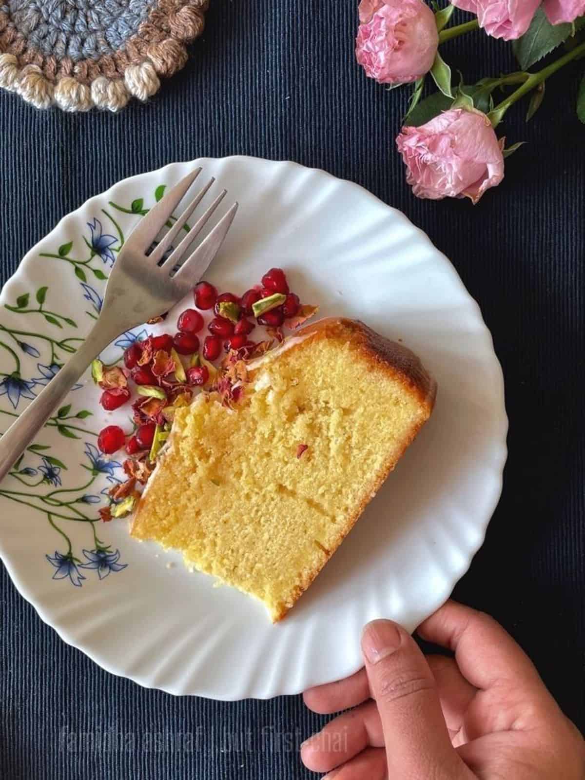 a slice of persian saffron cake with pomegranate arils.