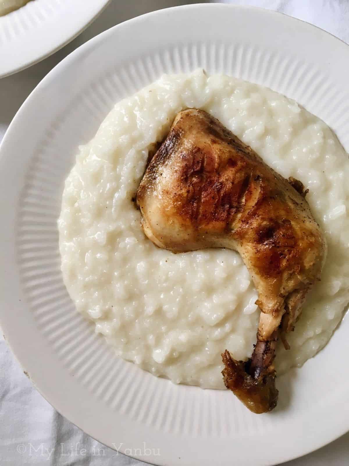 creamy Saleeg topped with a whole chicken leg roast