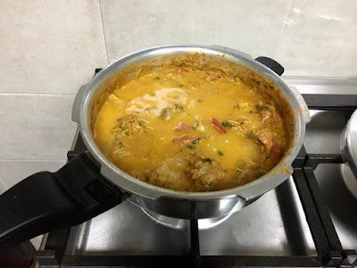 mutton gravy for mutton biryani in a pressure cooker pan. 
