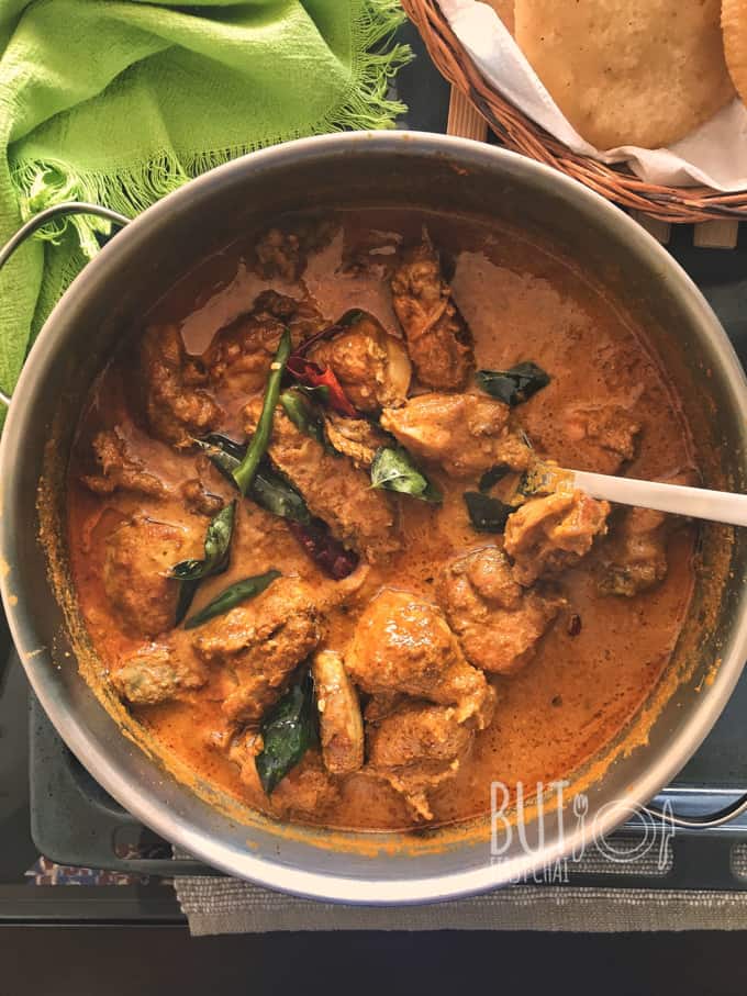 malabar chicken curry in a pot with a ladle