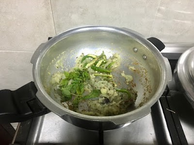 sauteing ginger-garlic paste, green chillies and mint leaves