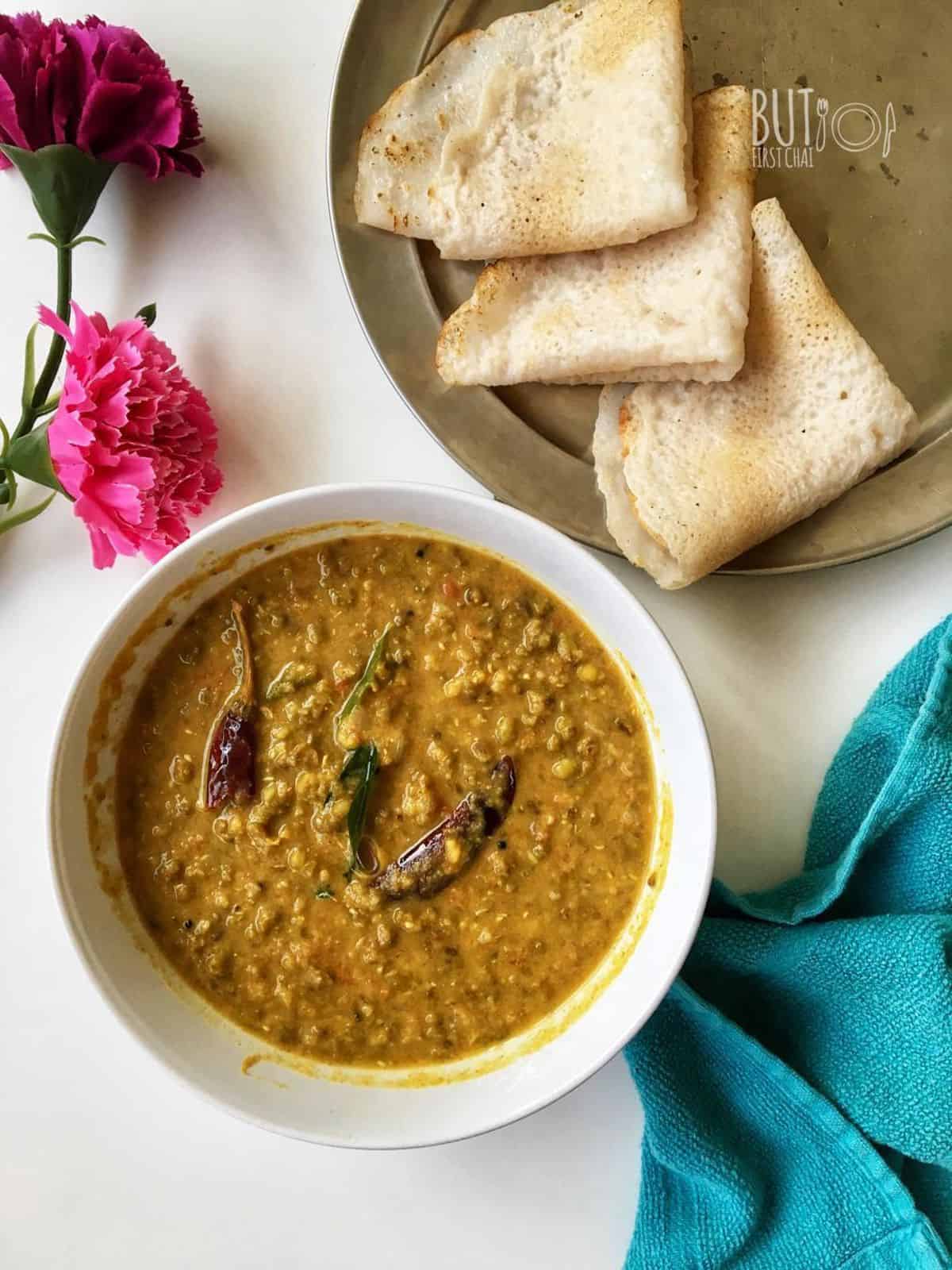 a bowl of cherupayar curry served with ari dosha