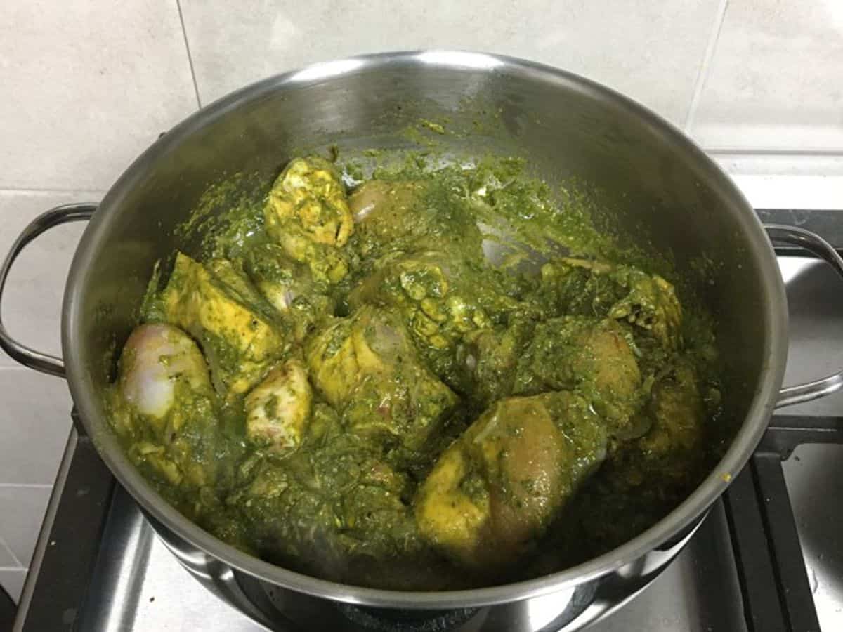 chicken cooking with green paste