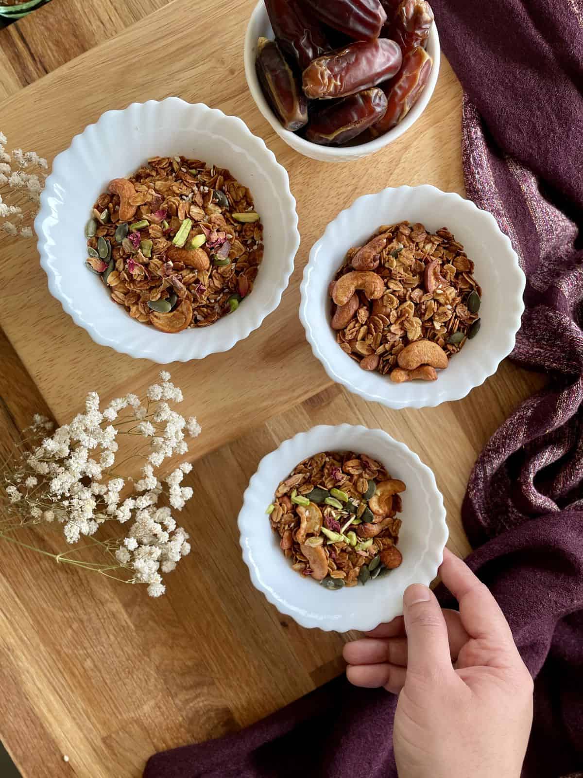 three bowls of date paste granola with a bowl of dates