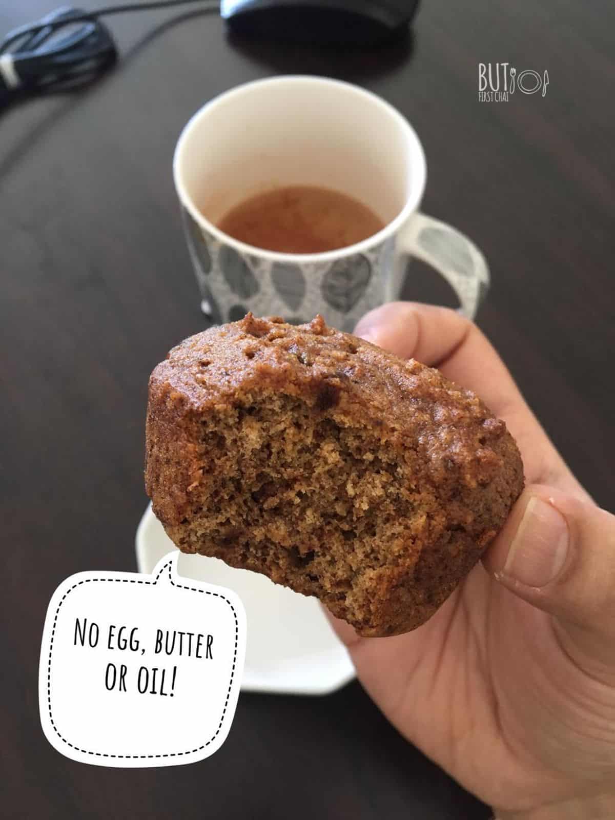 dates muffin half bitten served with cup of chai
