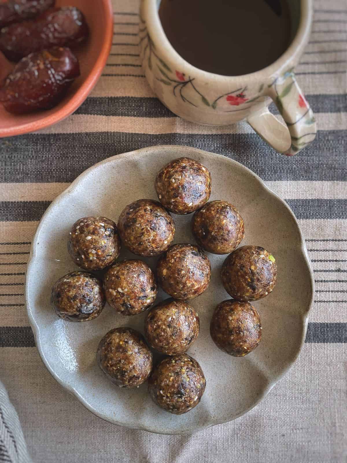 A plate of energy balls served with cuppa.