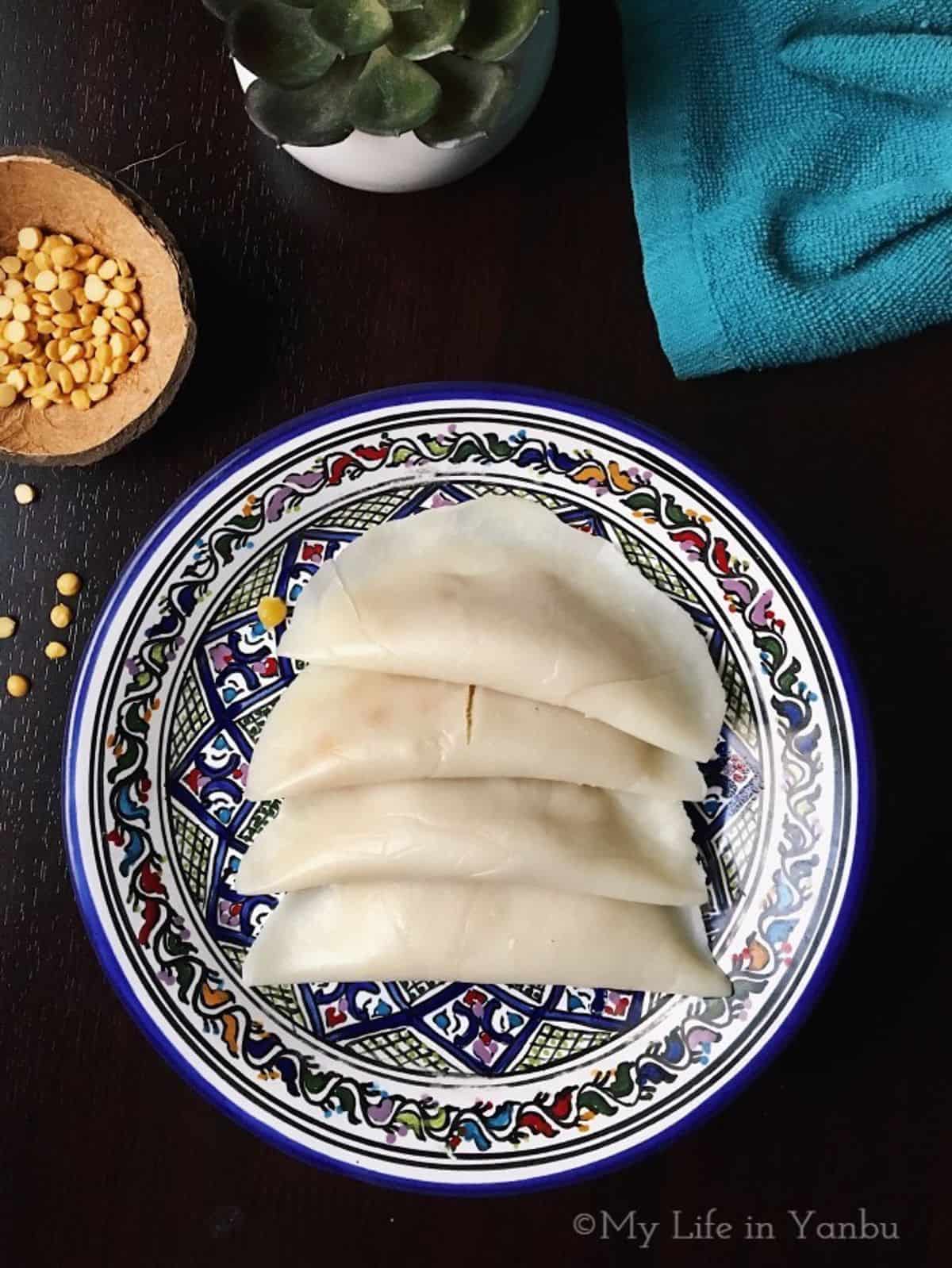 a plate of sweet bengal gram parcels.