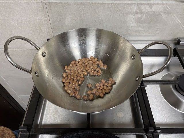 peanuts being fried in coconut oil.