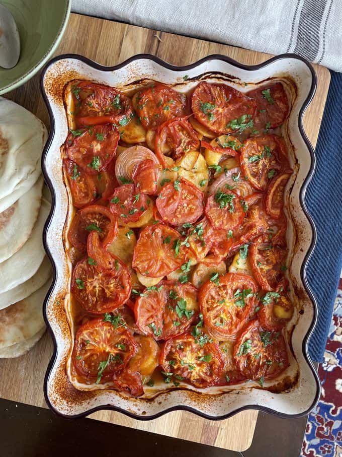 a large dish of baked kafta bi sanieh which is layers of mea, potato and tomato baked.