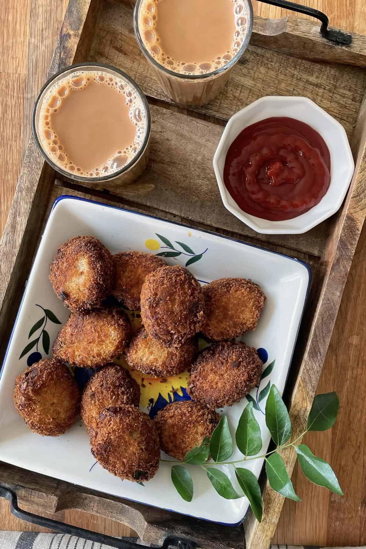chicken cutlets, ketchup and two cups of chai