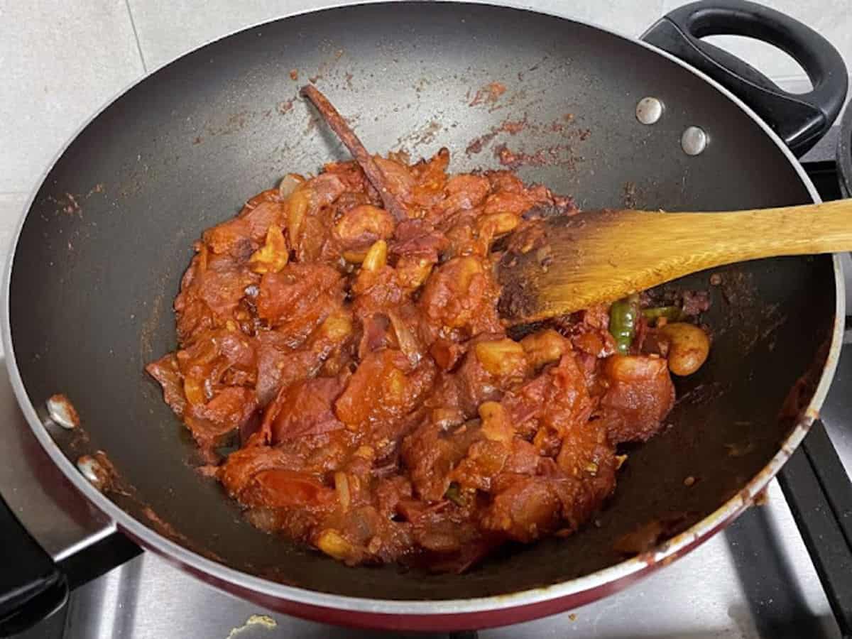 cooking down fresh tomato in spices