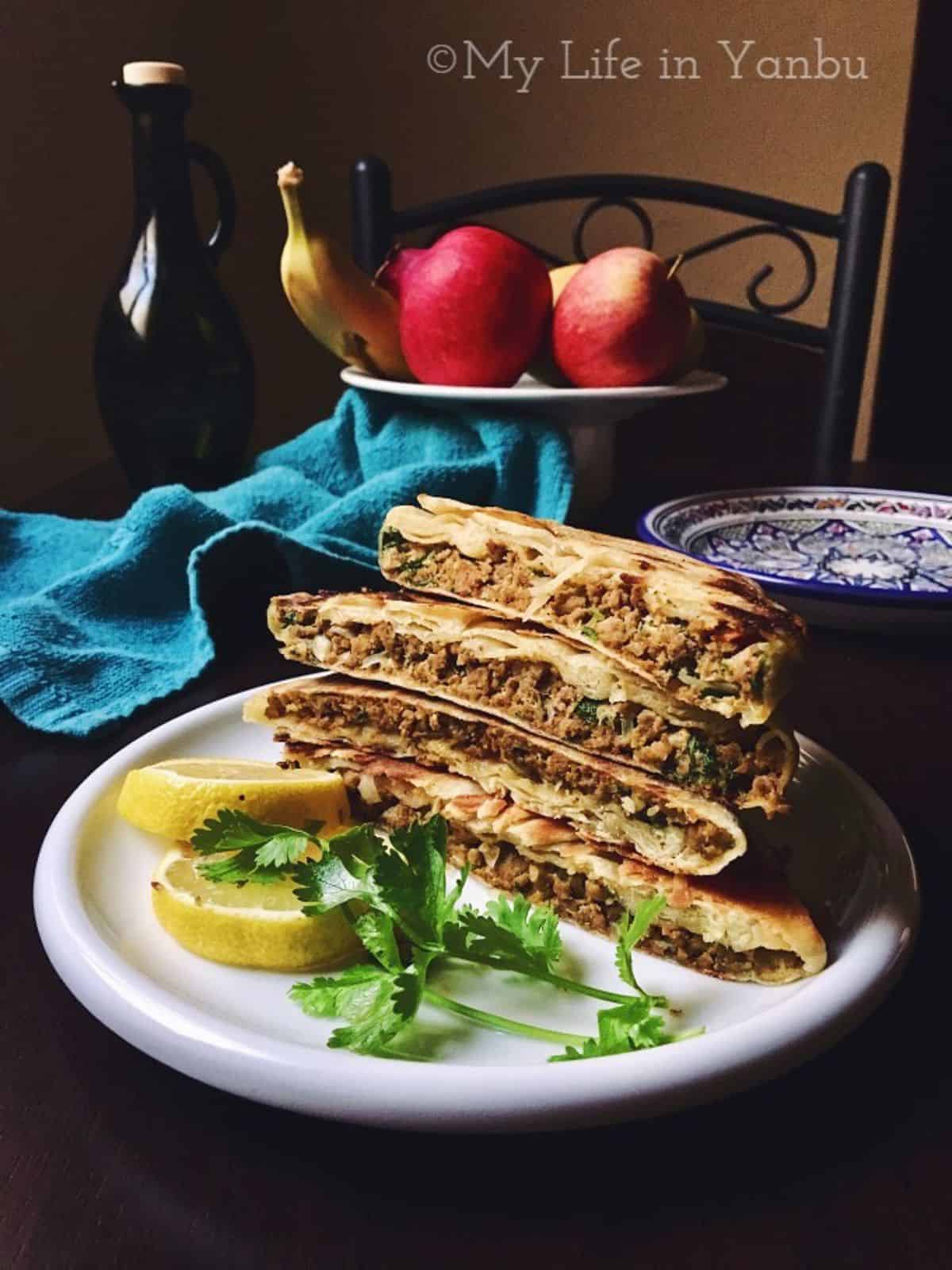 a stack of mutabbaq with lemon slices