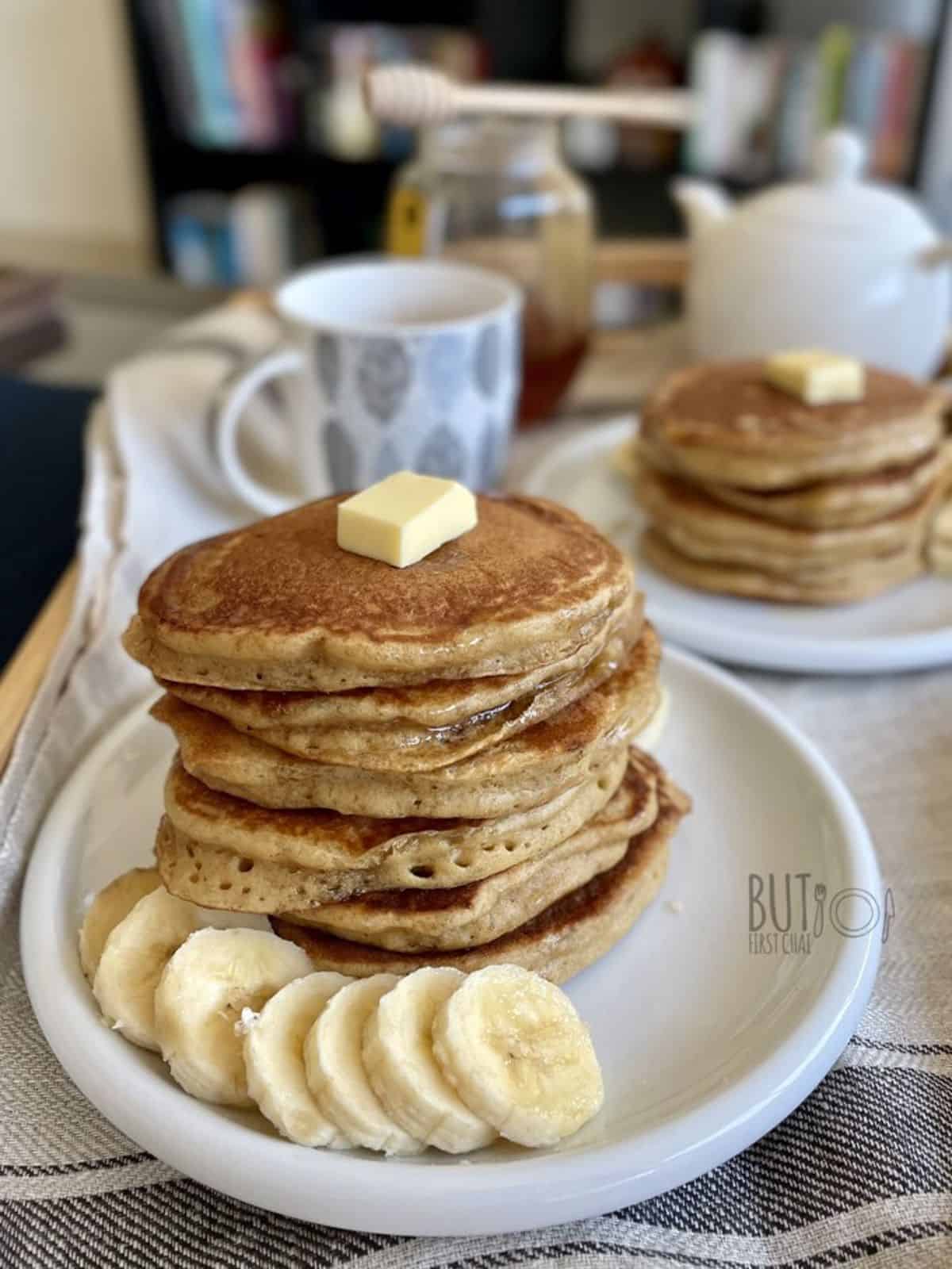 oat flour pancakes stack served with sliced banana