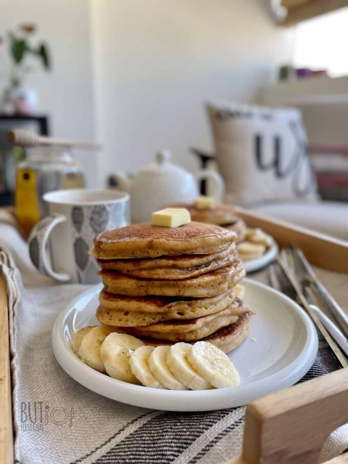 oat flour pancakes stack served with sliced banana