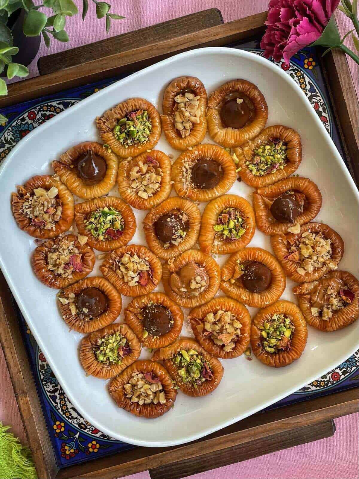 a platter filled with bracelet baklavas