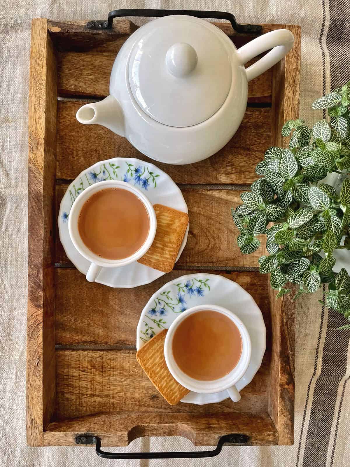 homemade masala chai served with biscuits
