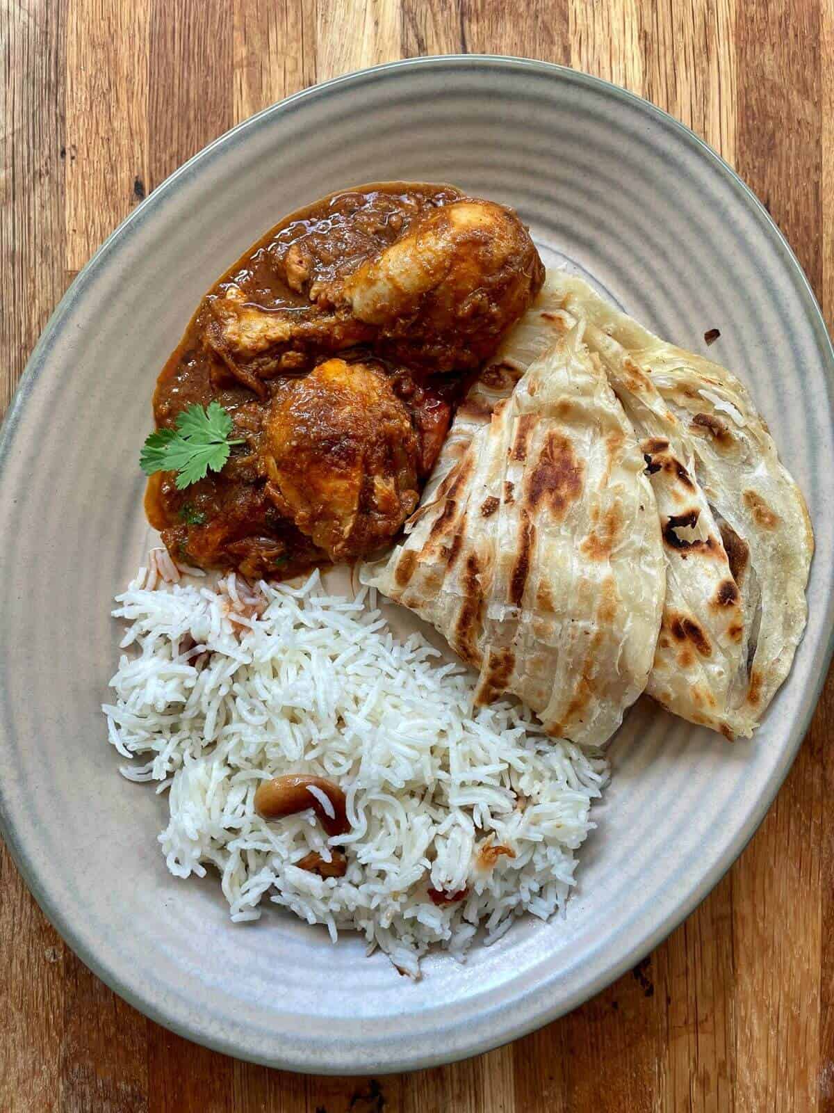 chicken chettinad gravy served with rice and porotta