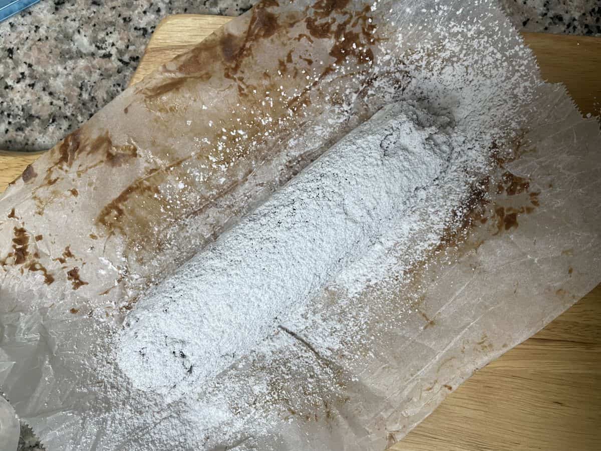 Powdered sugar dusted over the chilled chocolate sausage.