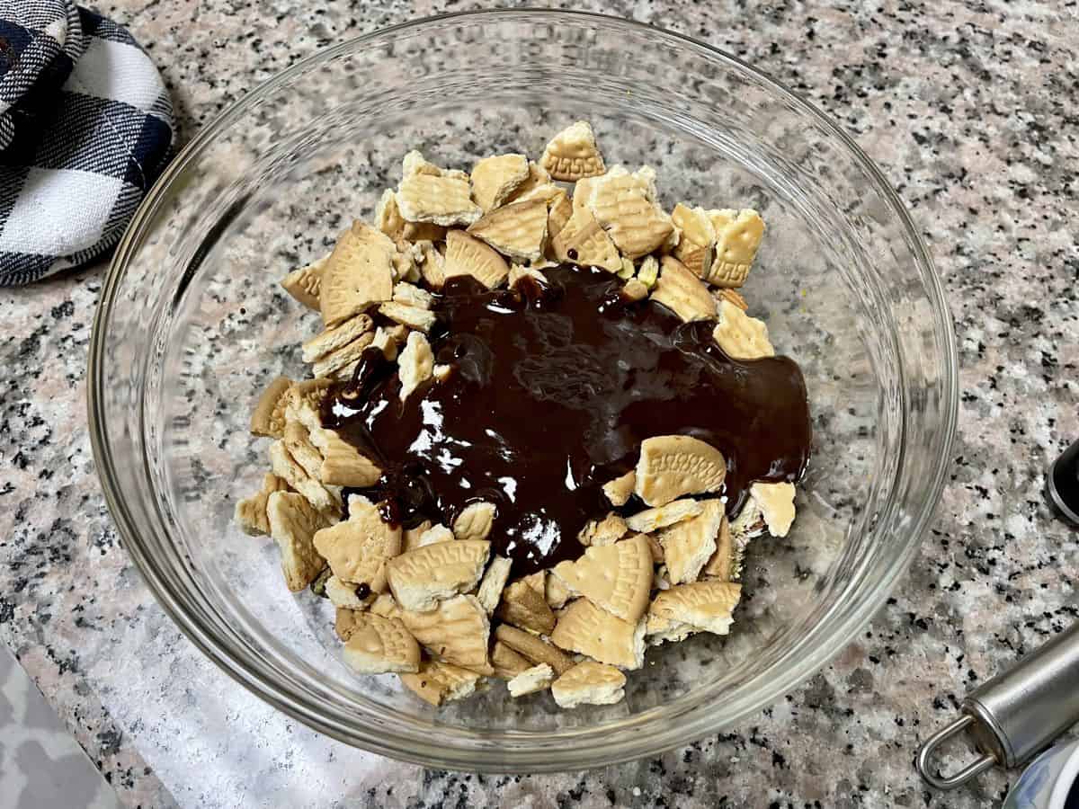 melted chocolate over crushed marie biscuits.